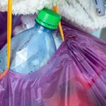 teenager recycling bottles