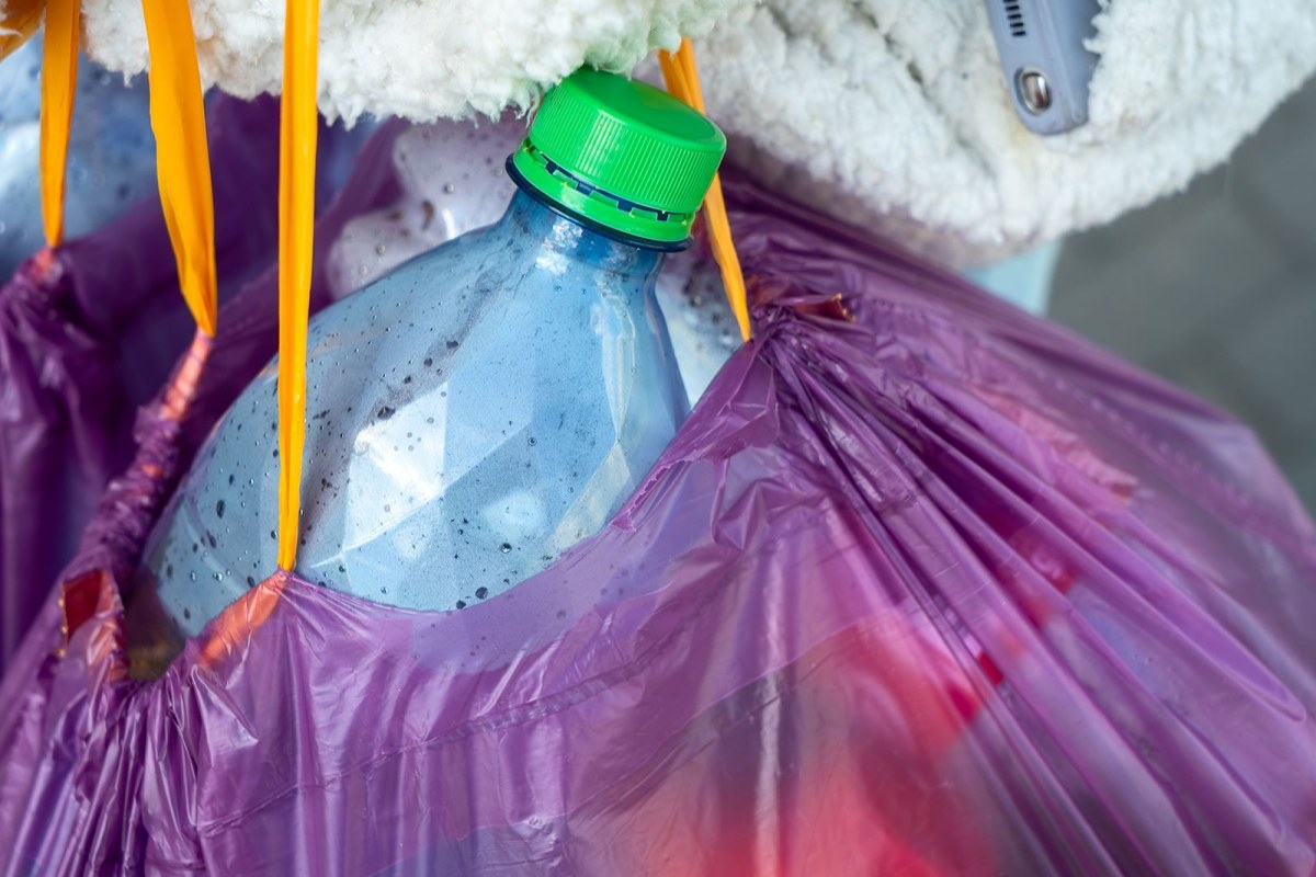 teenager recycling bottles