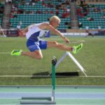 Jakub Szymanski running hurdles