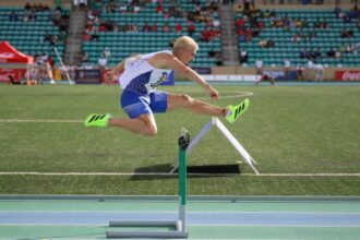 Jakub Szymanski running hurdles