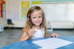 child doing homework in classroom