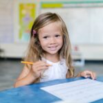 child doing homework in classroom